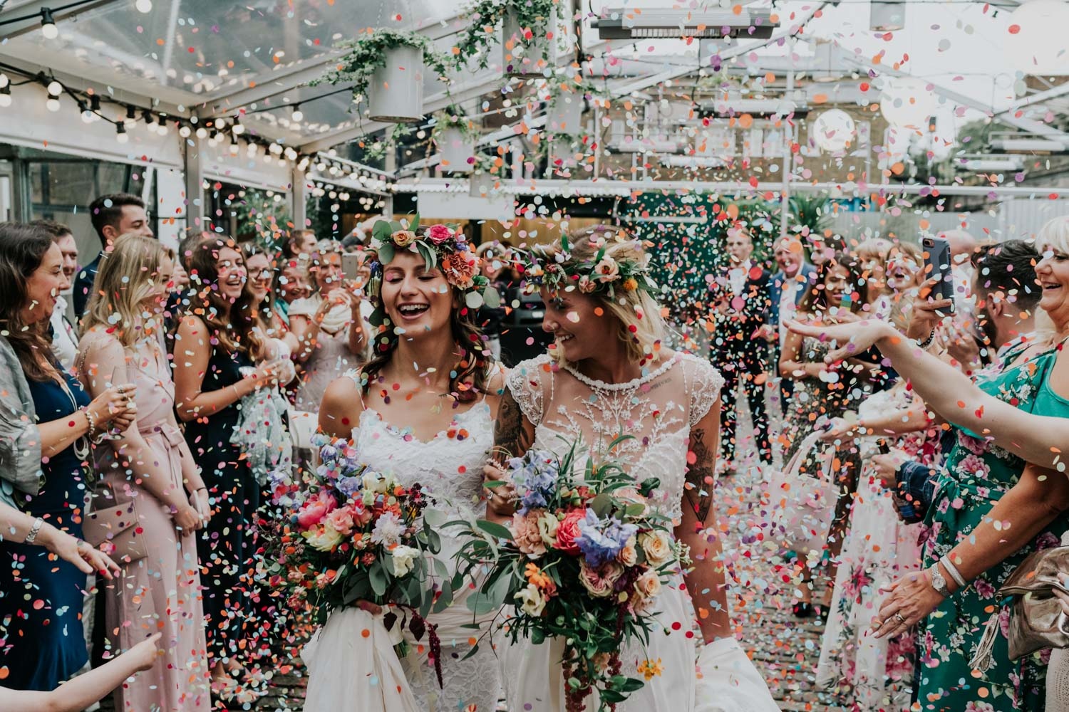 two brides showered in confetti