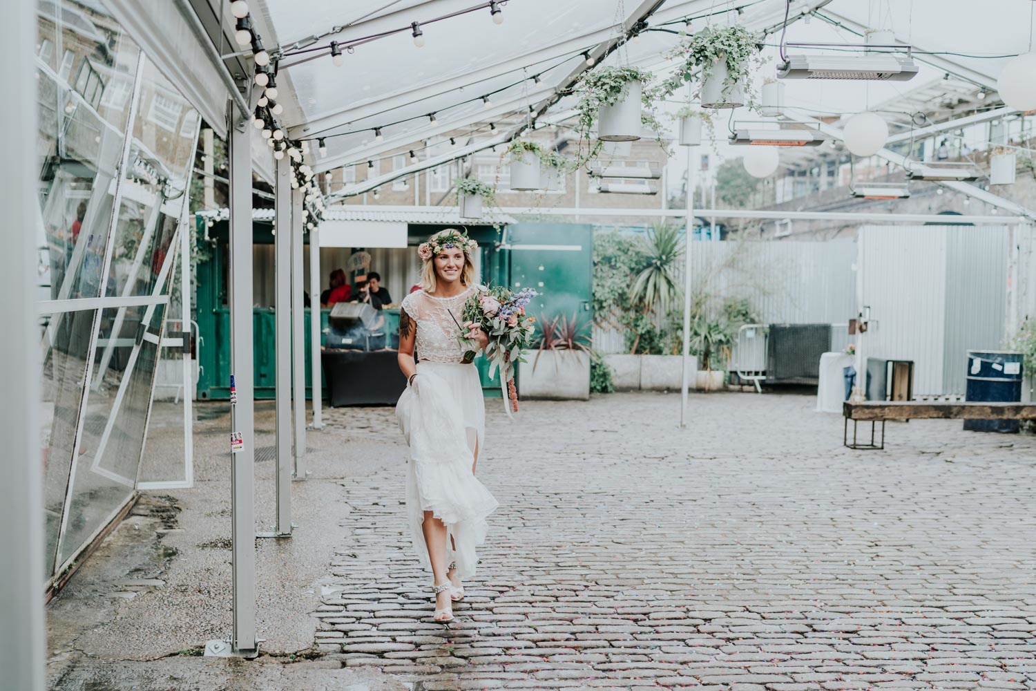 bride in lace dresses and flower crown walking