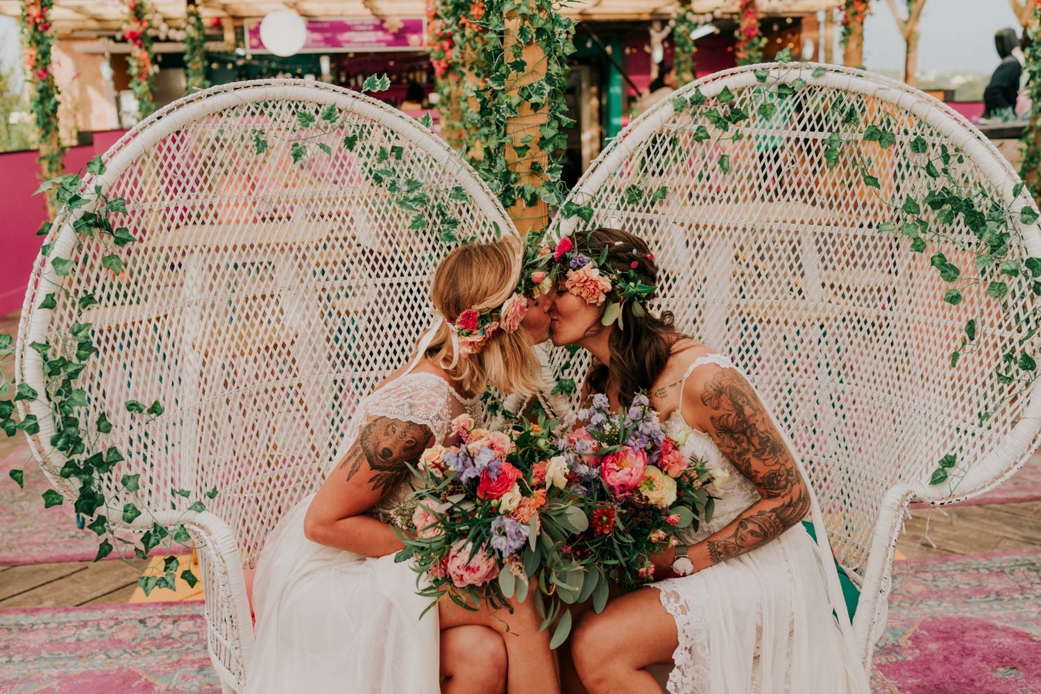 two tattooed lesbian brides kissing