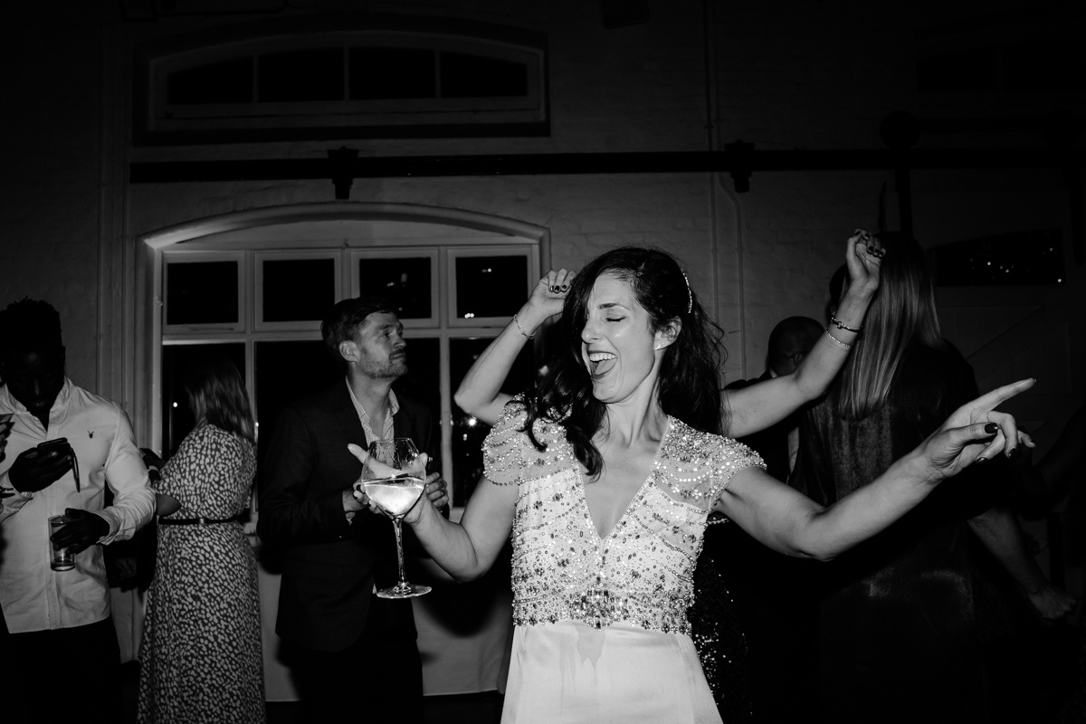bride dancing with a glass of wine