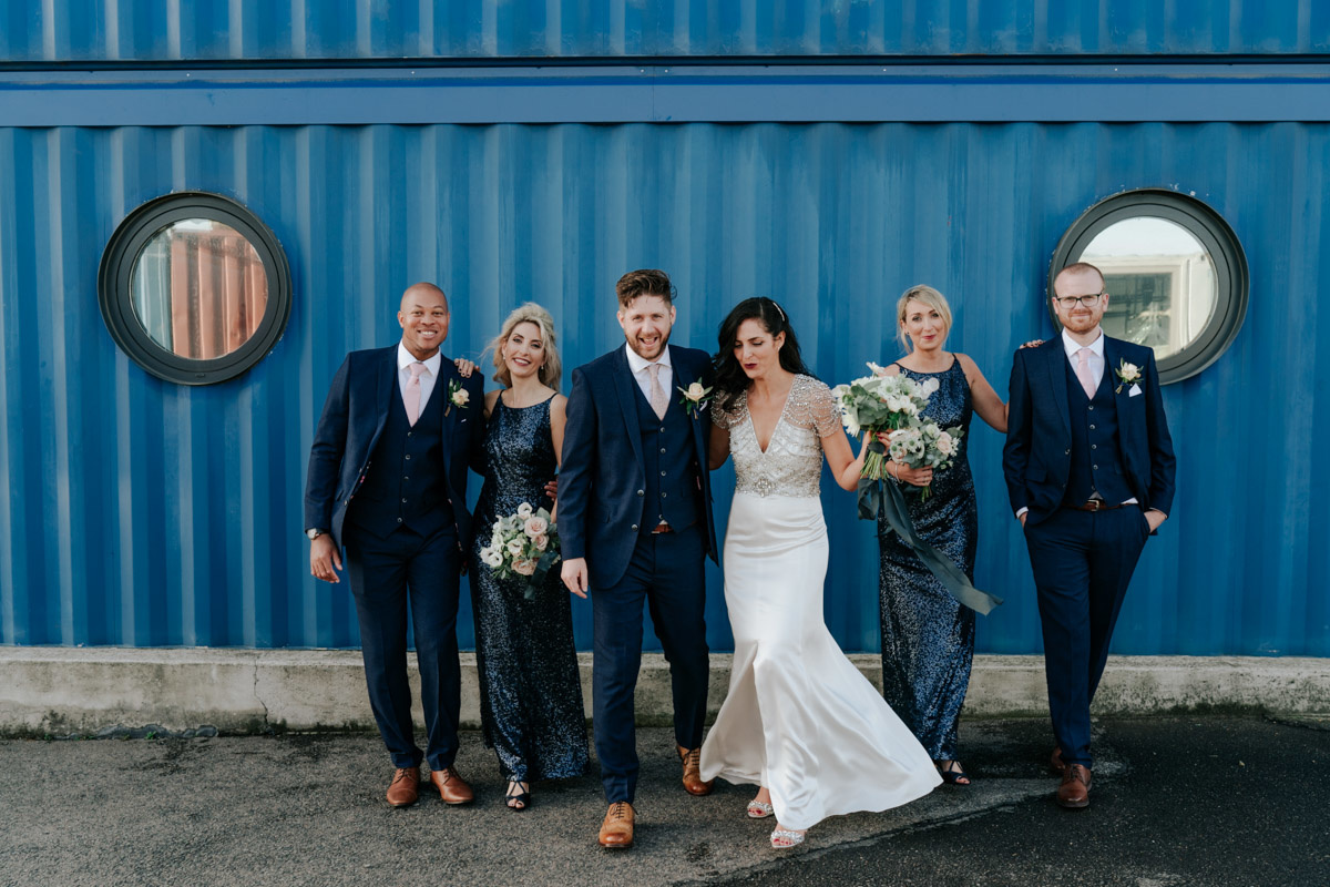 wedding party dancing in front of blue sea container at trinity buoy wharf