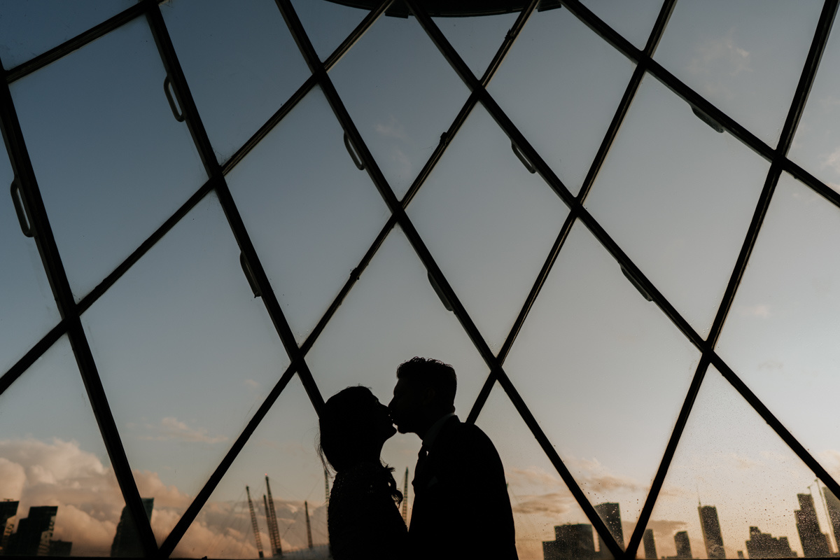 silhouette of couple kissing in london lighthouse