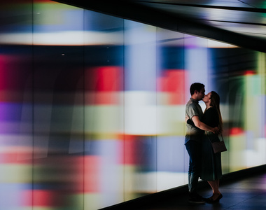 london engagement photography with couple kissing in colourful tunnel