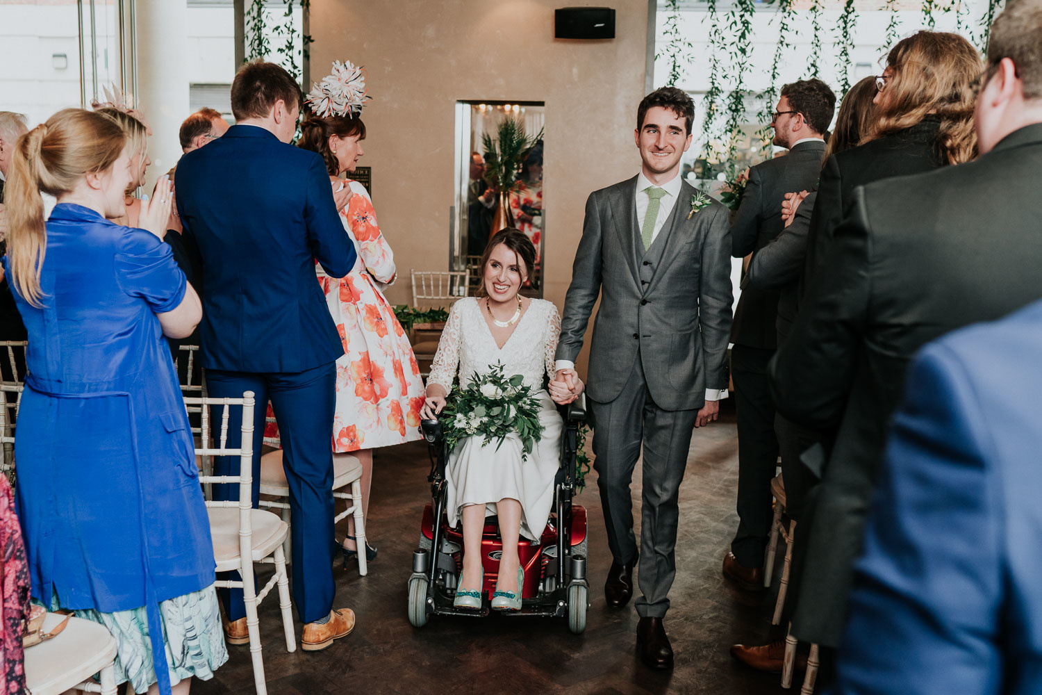 disabled bride and groom exiting ceremony together