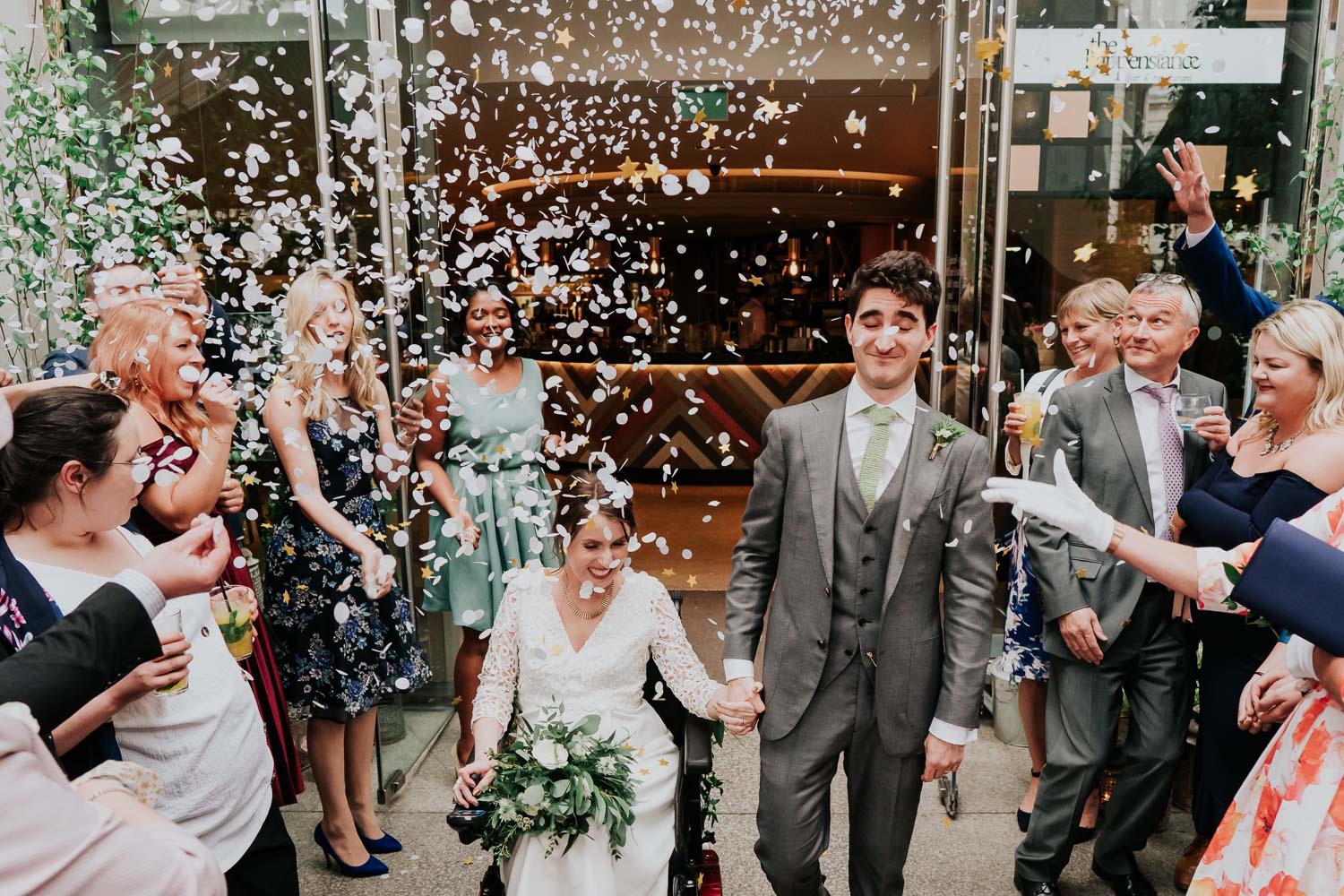 disabled bride in a wheelchair and groom's confetti shower