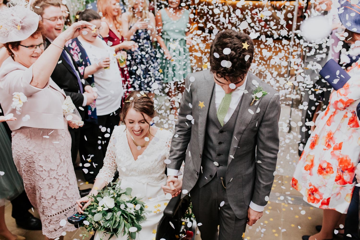 bride with disability in a wheelchair and groom confetti