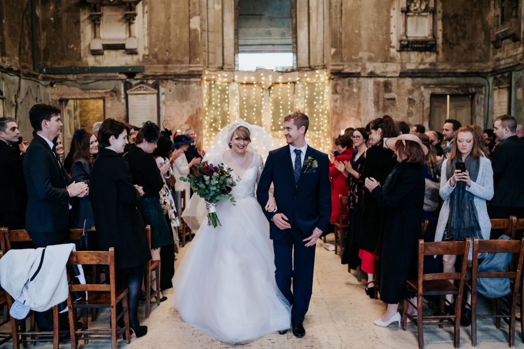 bride and groom aisle walk at asylum chapel wedding venue