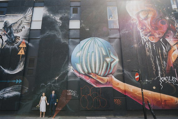 east london wedding in shoreditch with street art and relaxed couple standing by the wall