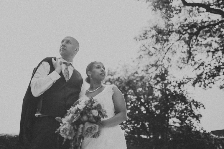surrey wedding photographer at great fosters wedding with bride and groom in an artistic pose looking away