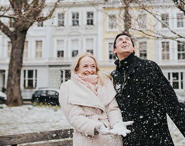 london engagement photographer capturing couple playing with snow during london winter