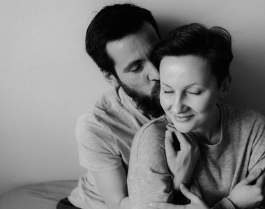 couple kissing in black and white photography in home engagement session