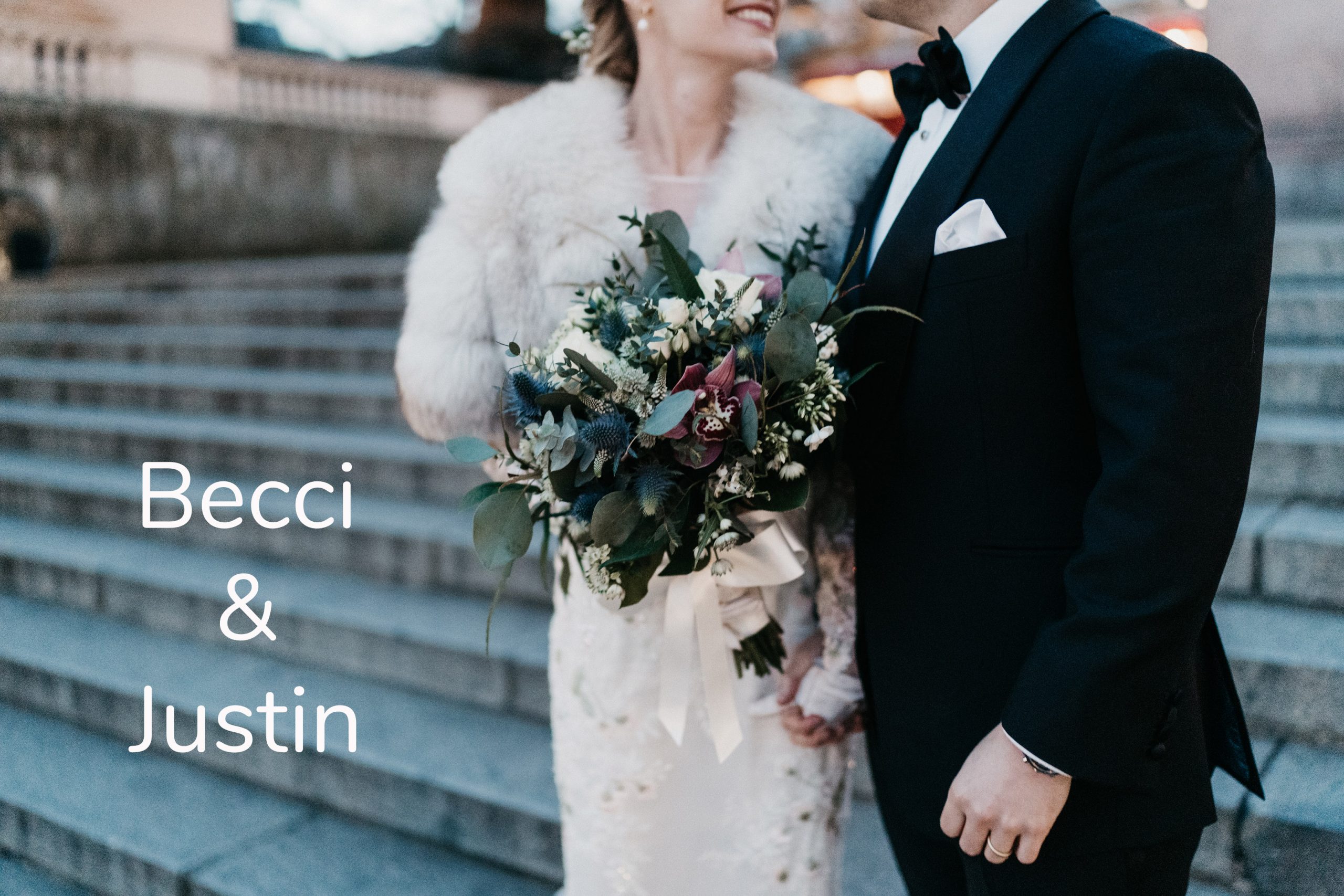 Bride and groom holding hands with bouquet in focs