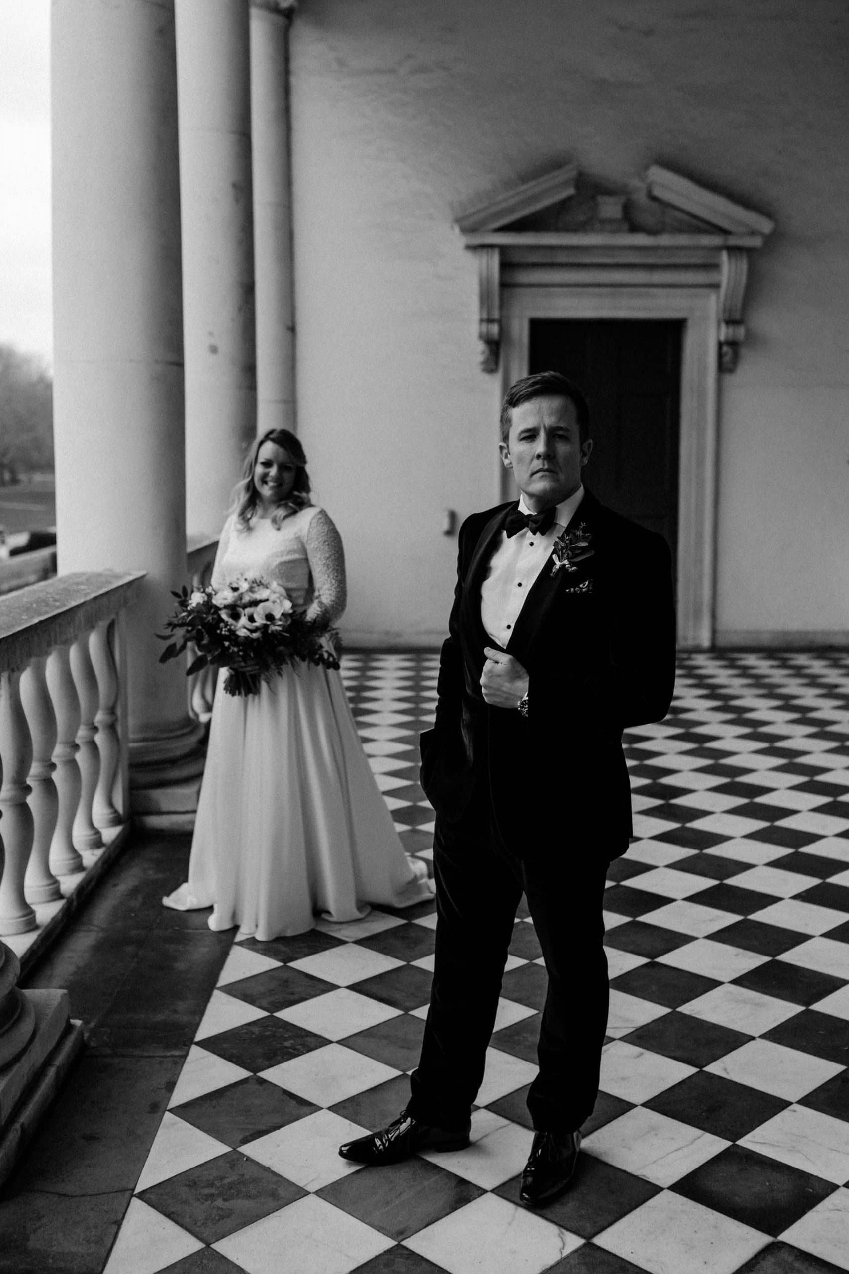 cool black and white photo of wedding couple in queens house balcony