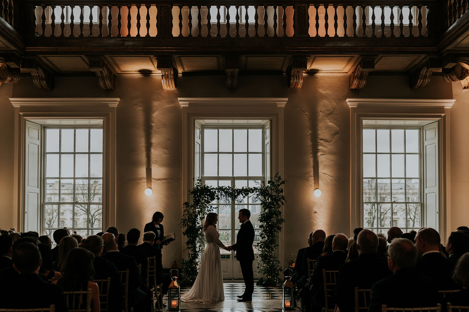 moody wedding ceremony photo at queens house winter great hall