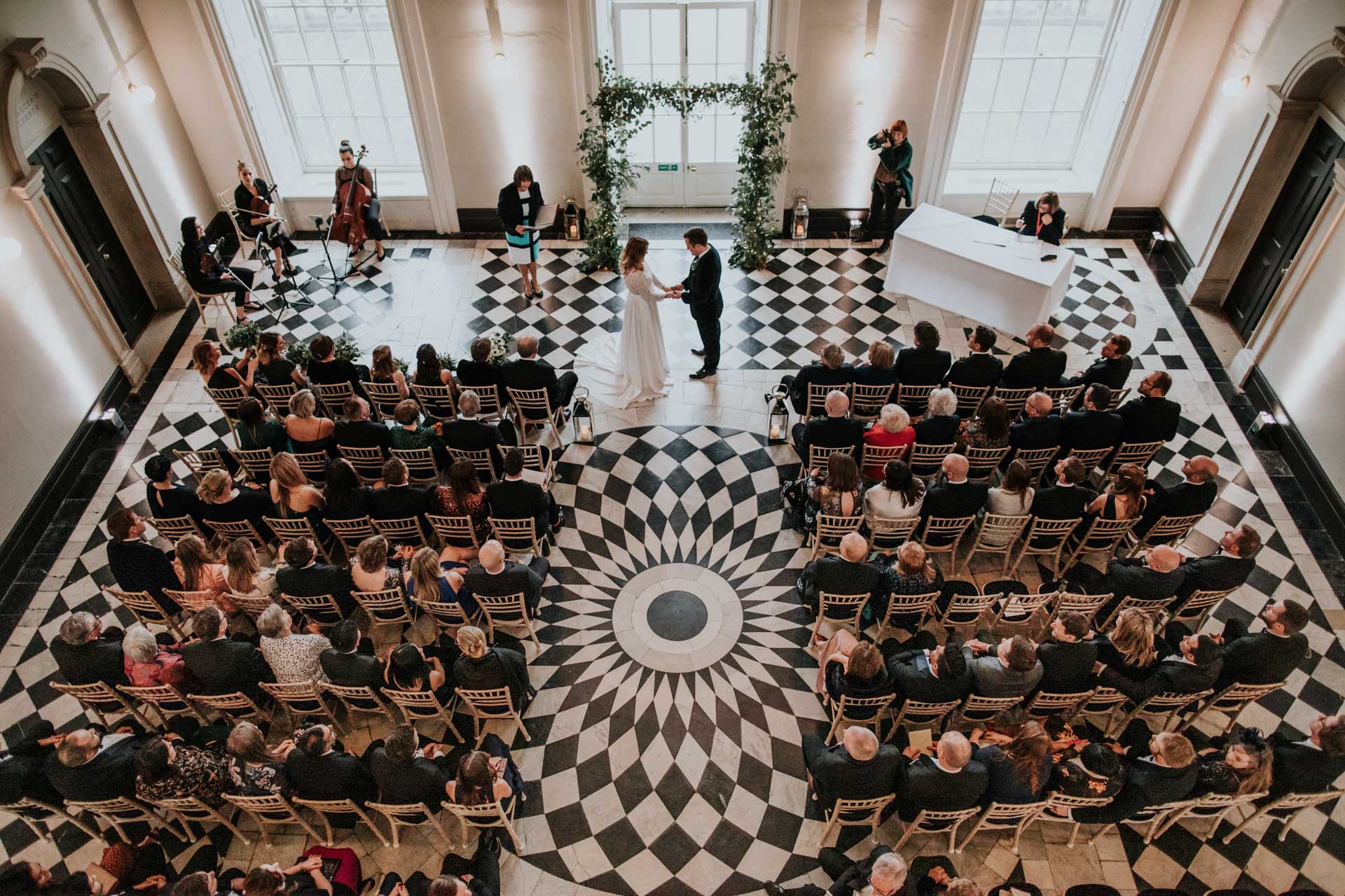 couple getting married in the great hall of queens house