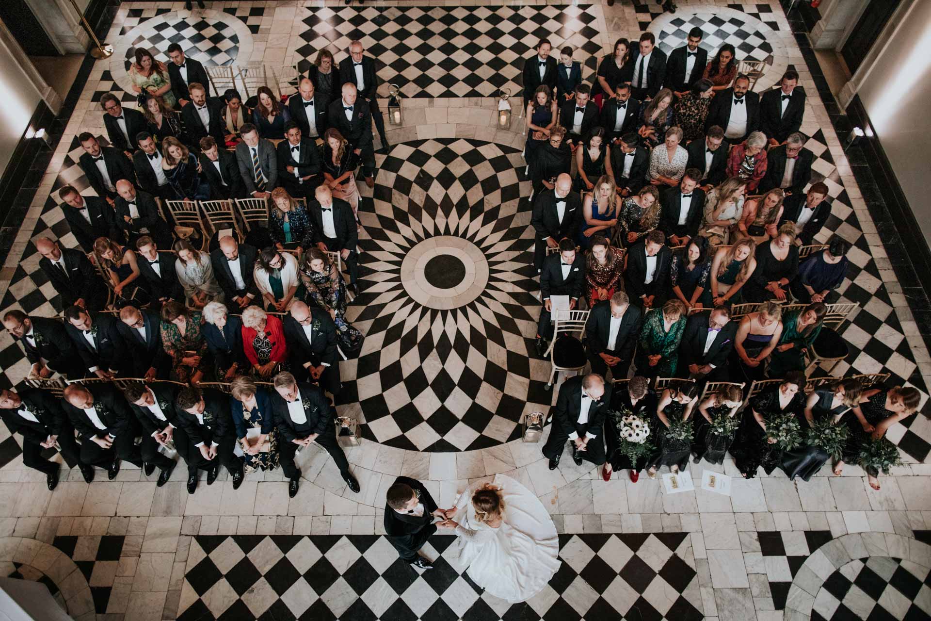 birds view of wedding ceremony with bride and groom holding hands in queens house