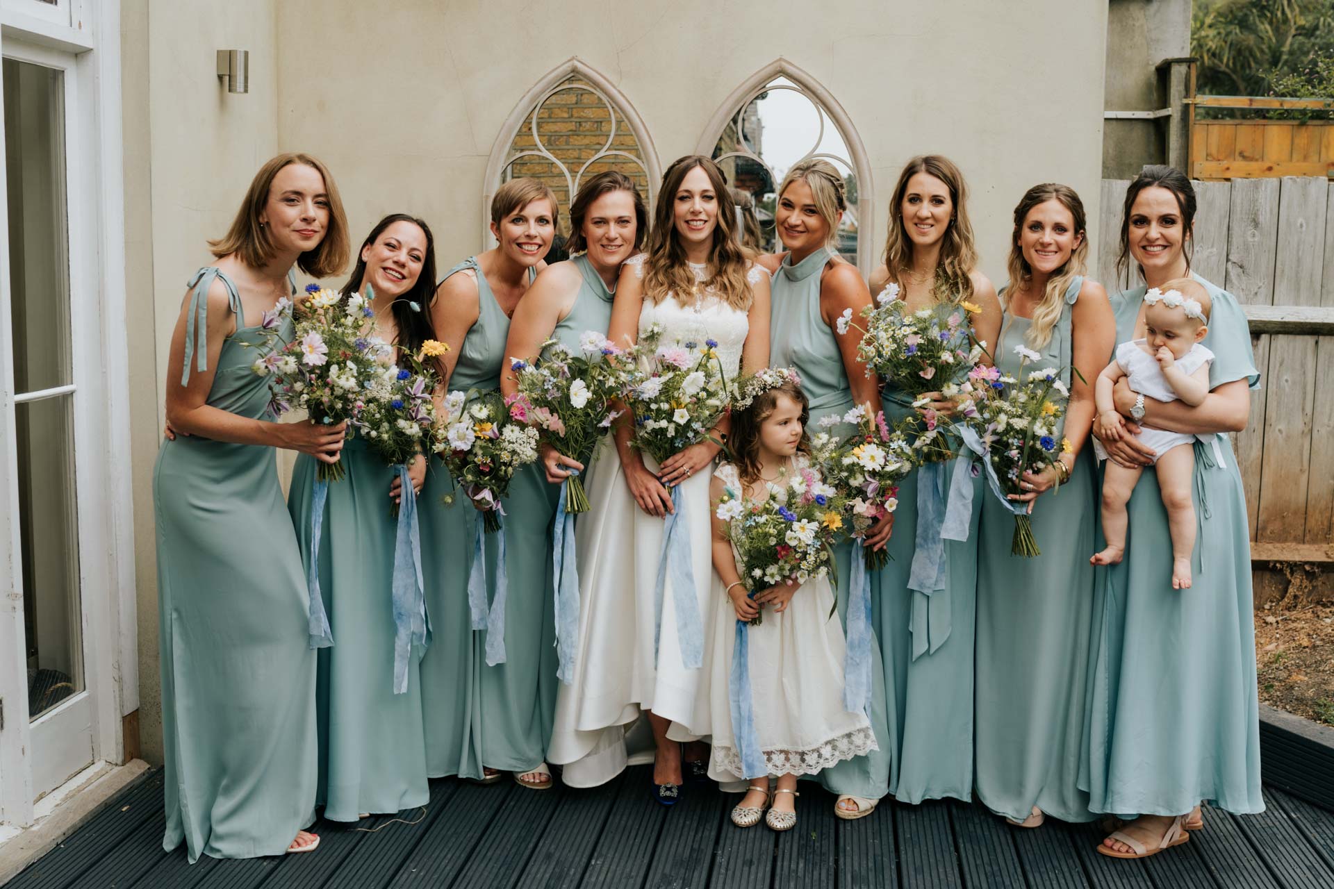 bride and bridesmaids in light blue silky dresses