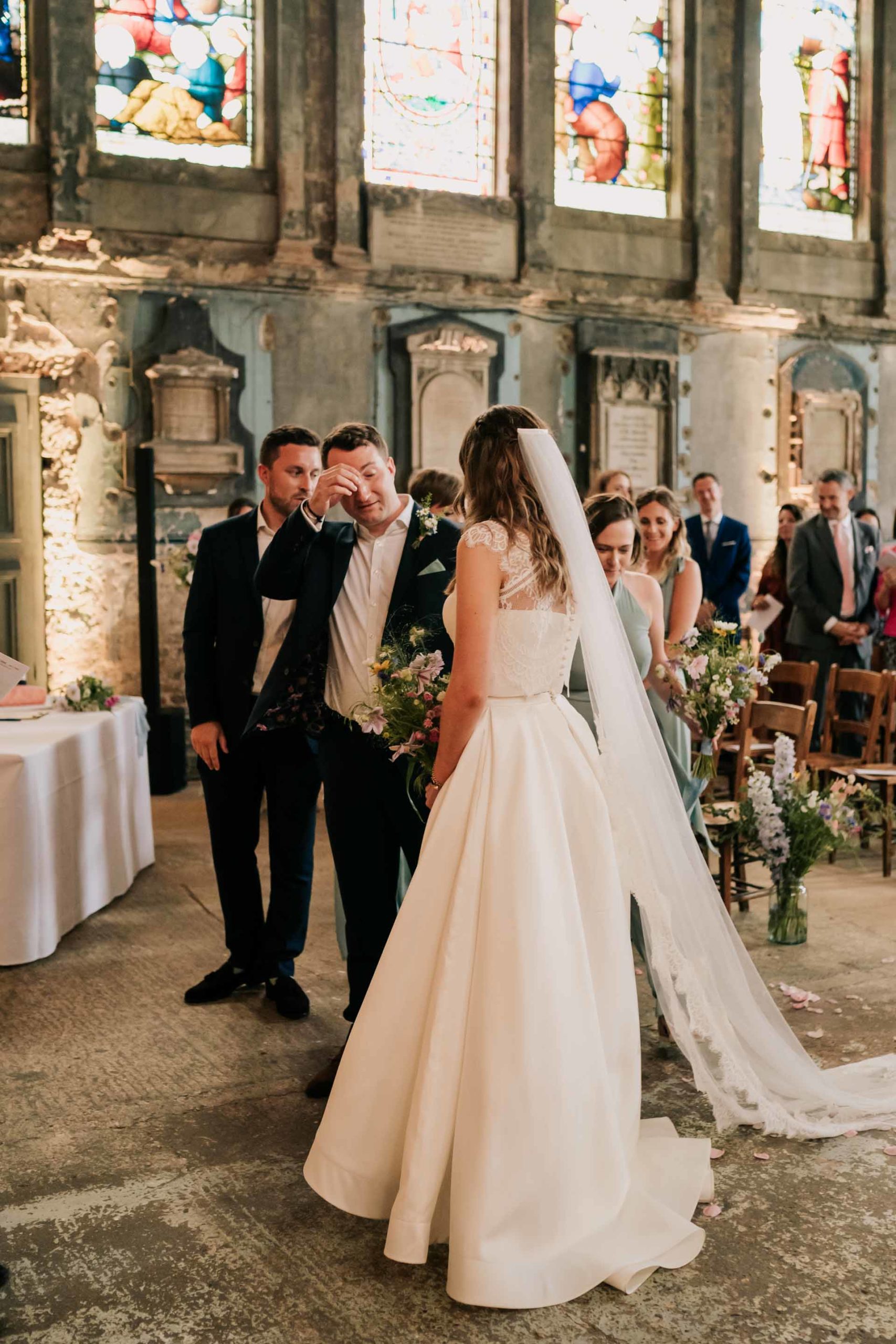 groom shedding a tear upon seeing his bride in asylum chapel