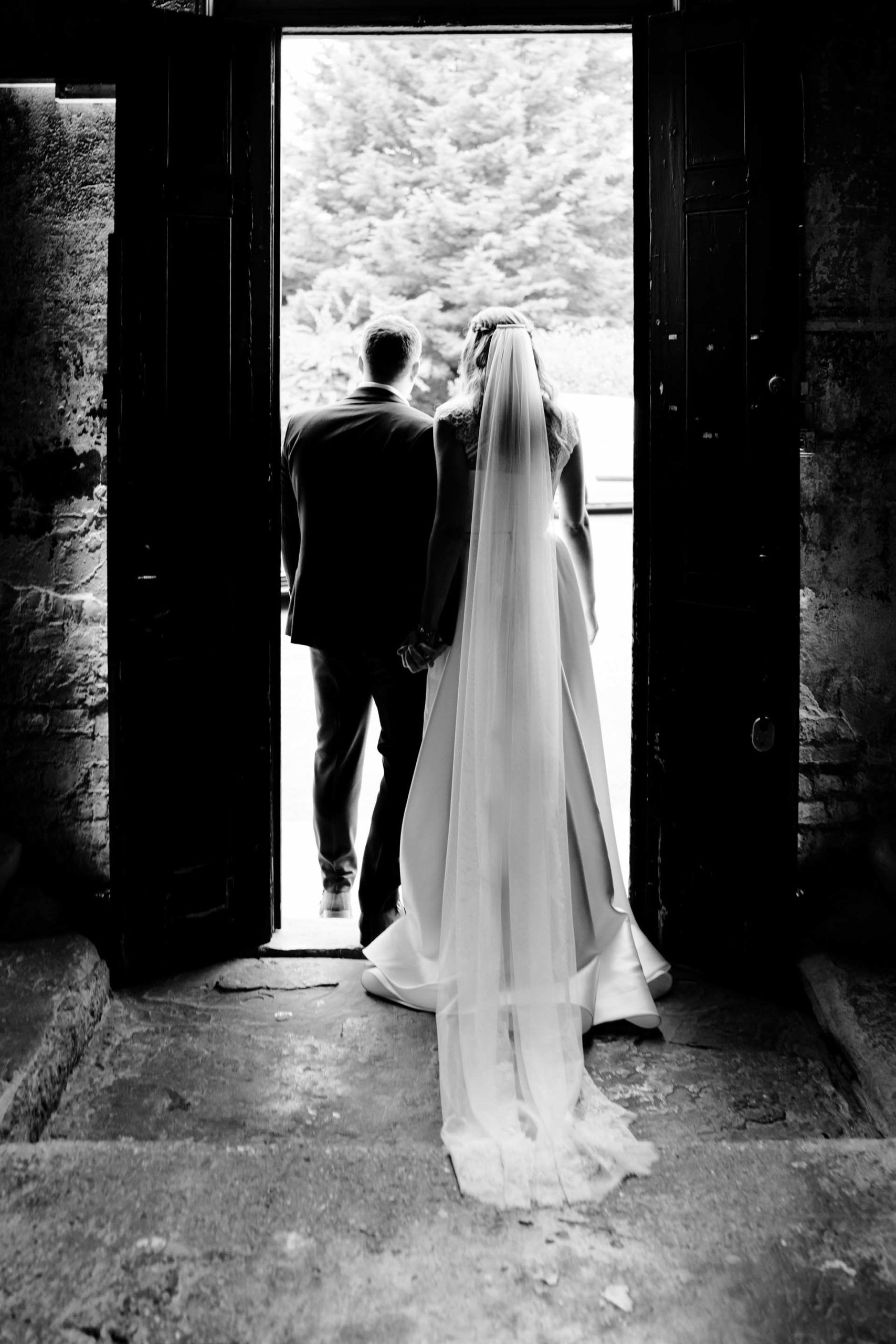 black and white portait of the groom and bride at the back