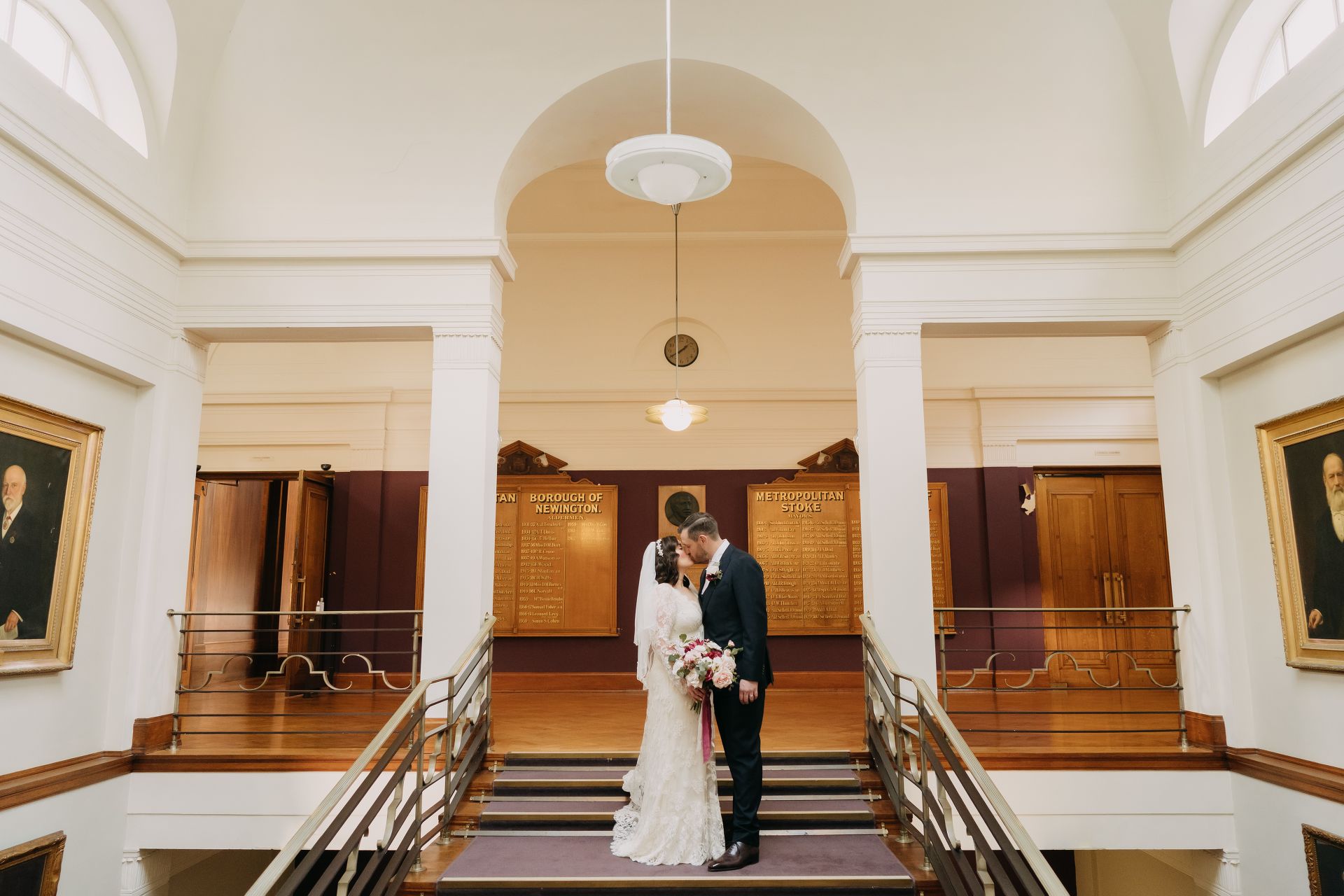 bride and groom kissing on steps of stoke newington town hall