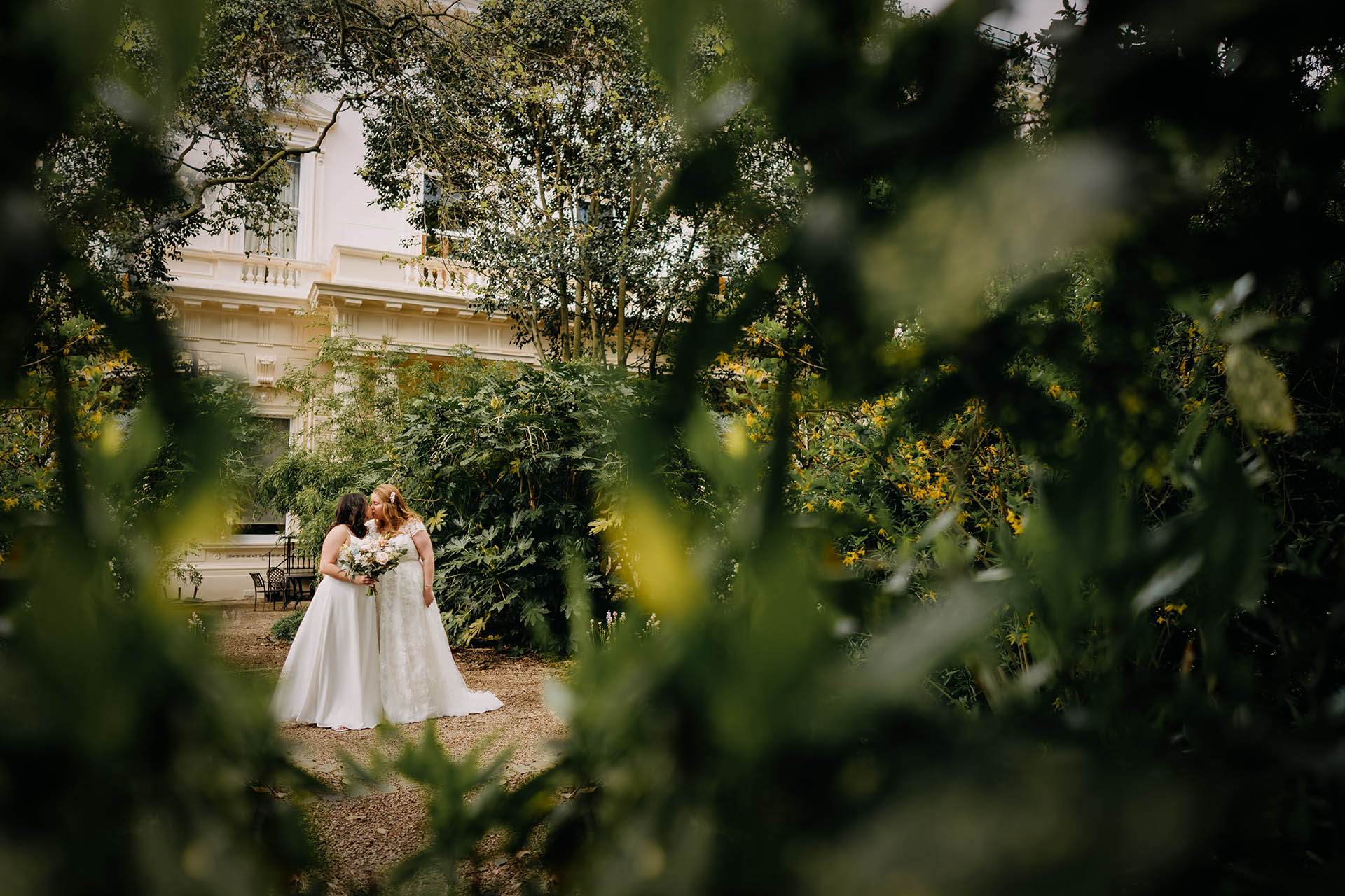 two brides kissing in 1011 carlton house terrace garden
