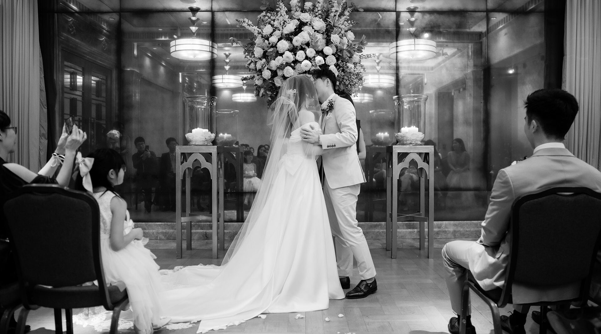 bride and groom kissing after ceremony at the connaught hotel, black and white wedding photo