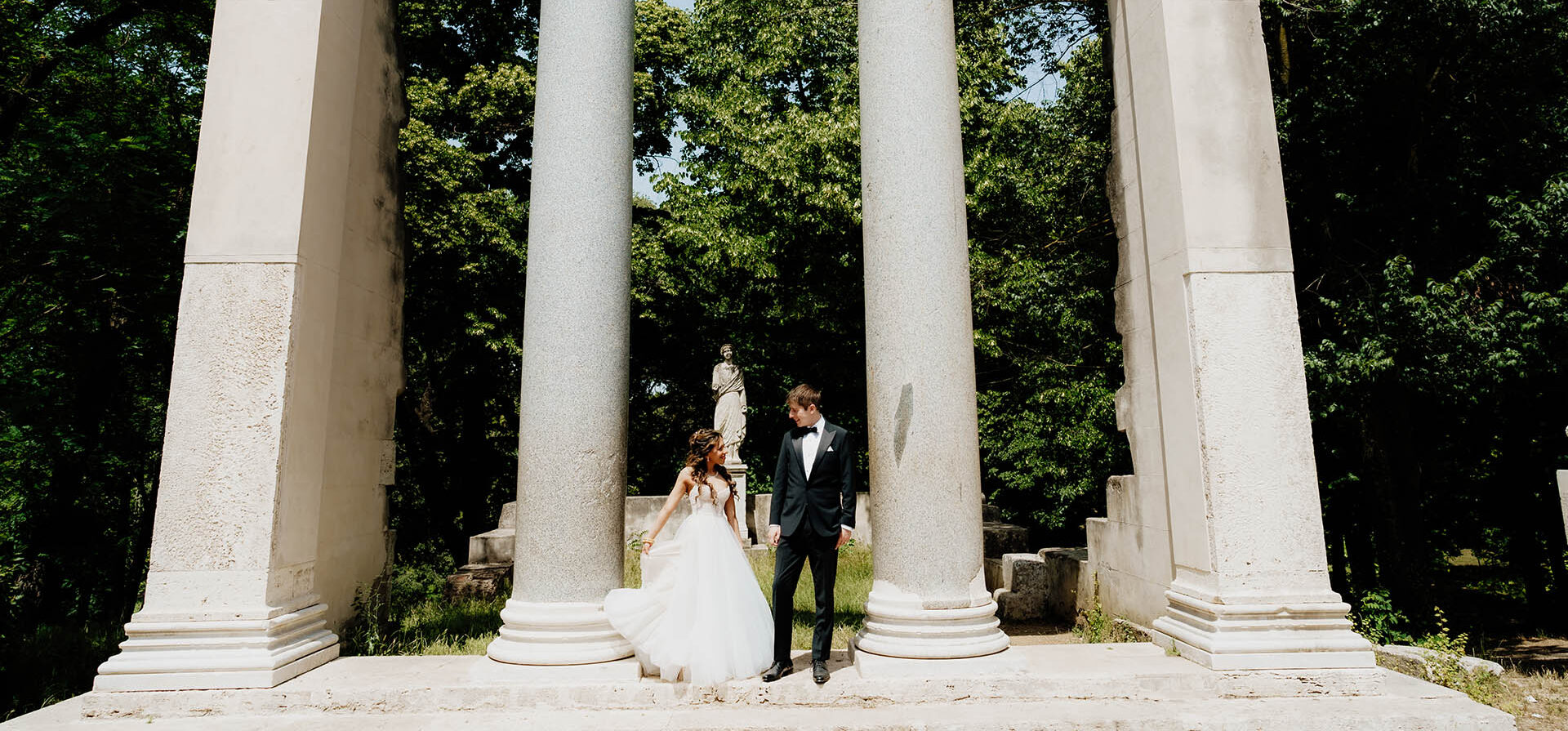 bride and groom posing for wedding photo at Italian monument in Rome