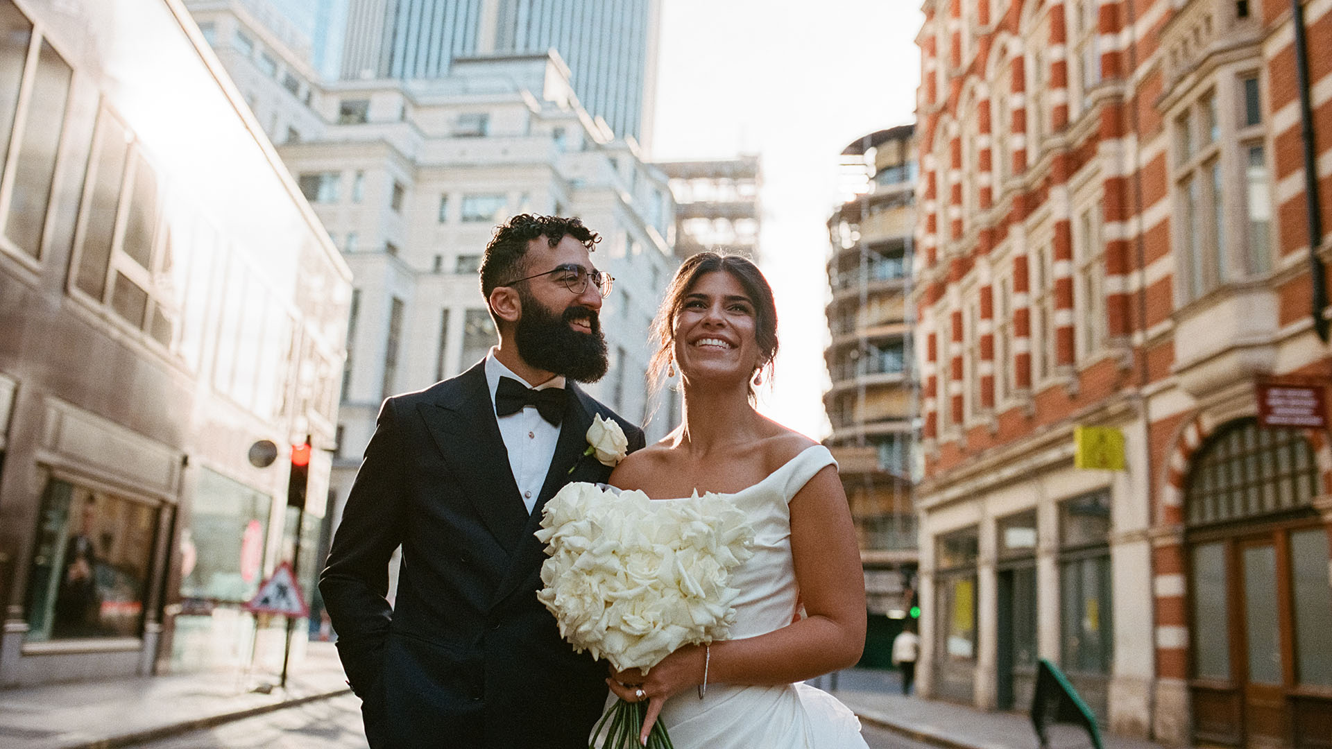 bride and groom smiling in the city of london by film wedding photographer