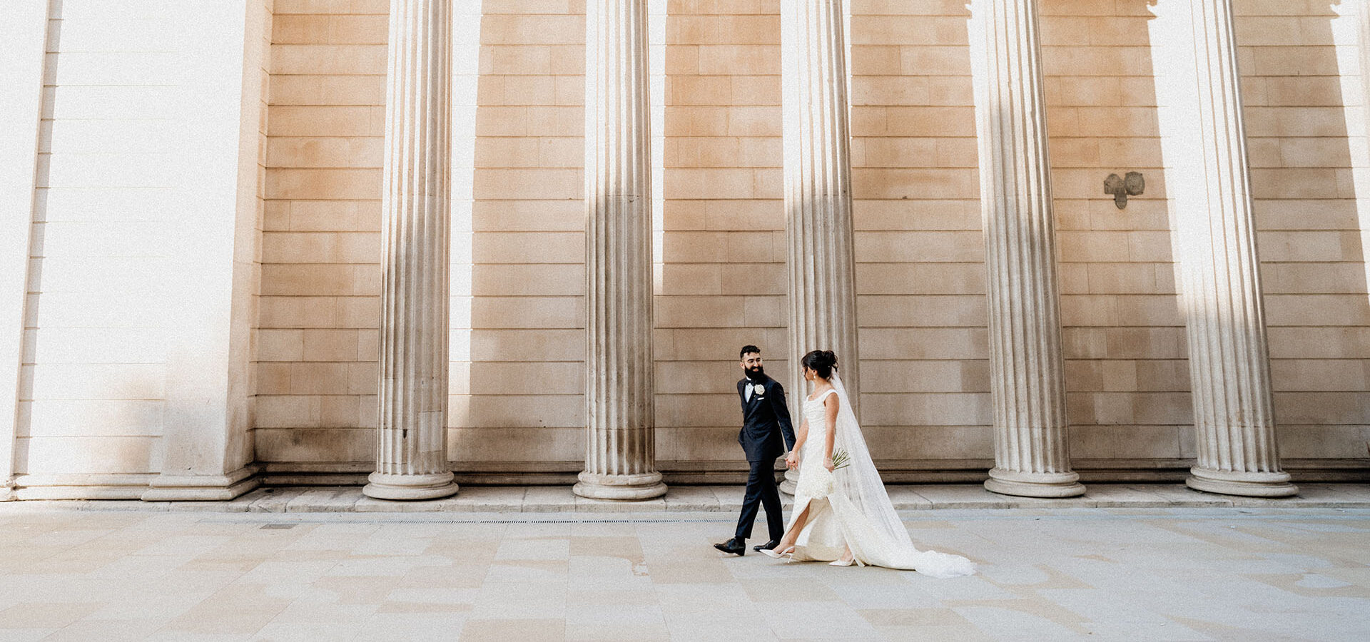 bride and groom walking in city of london captured by film wedding photographer