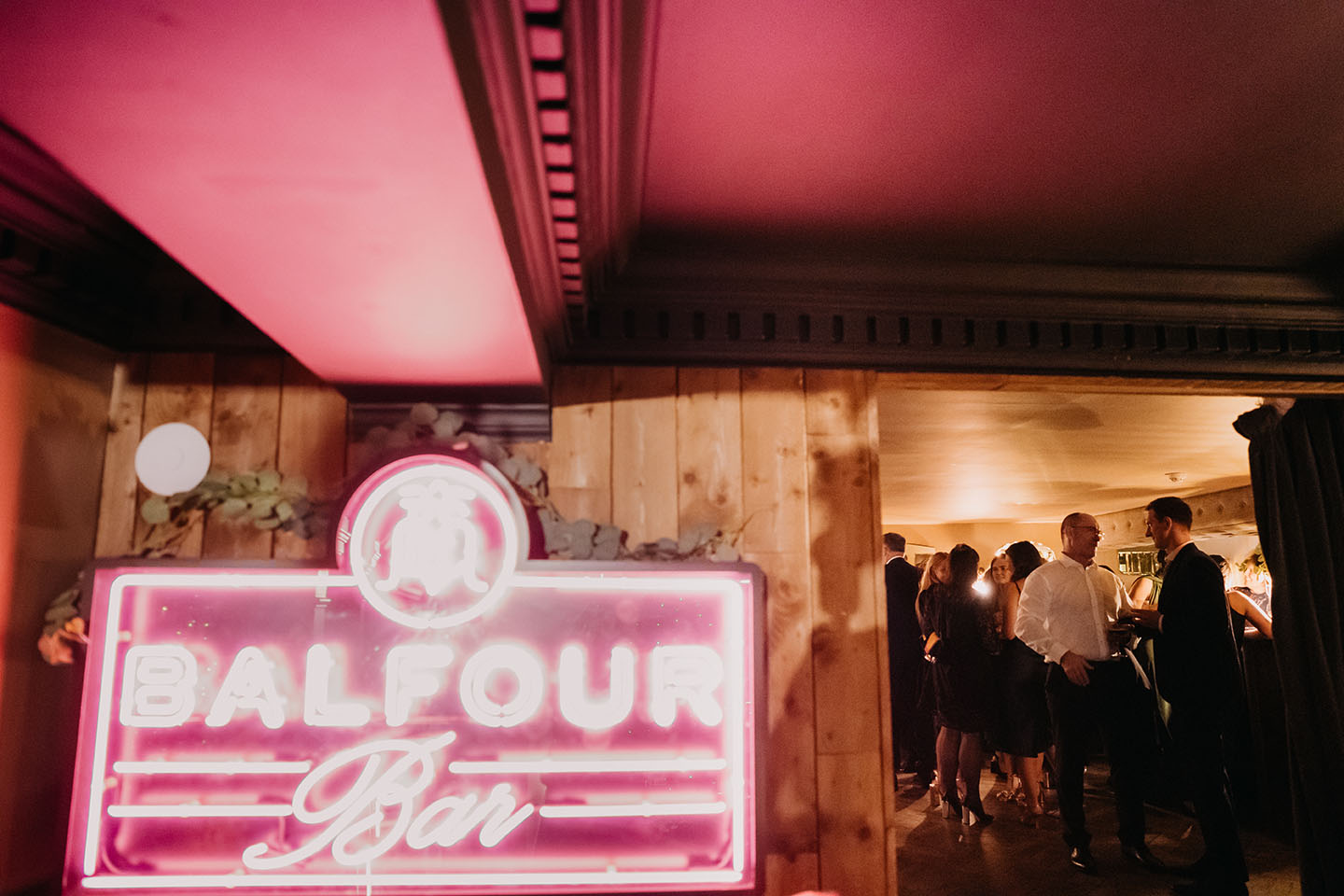 wedding party at balfour st barts with a neon sign on the left