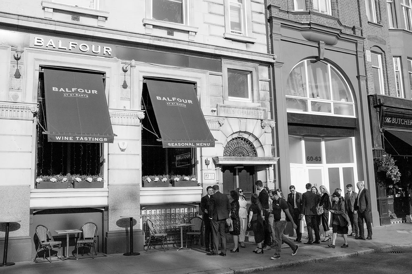 couple greeting wedding guests outside balfour at st barts wedding venue. in black and white