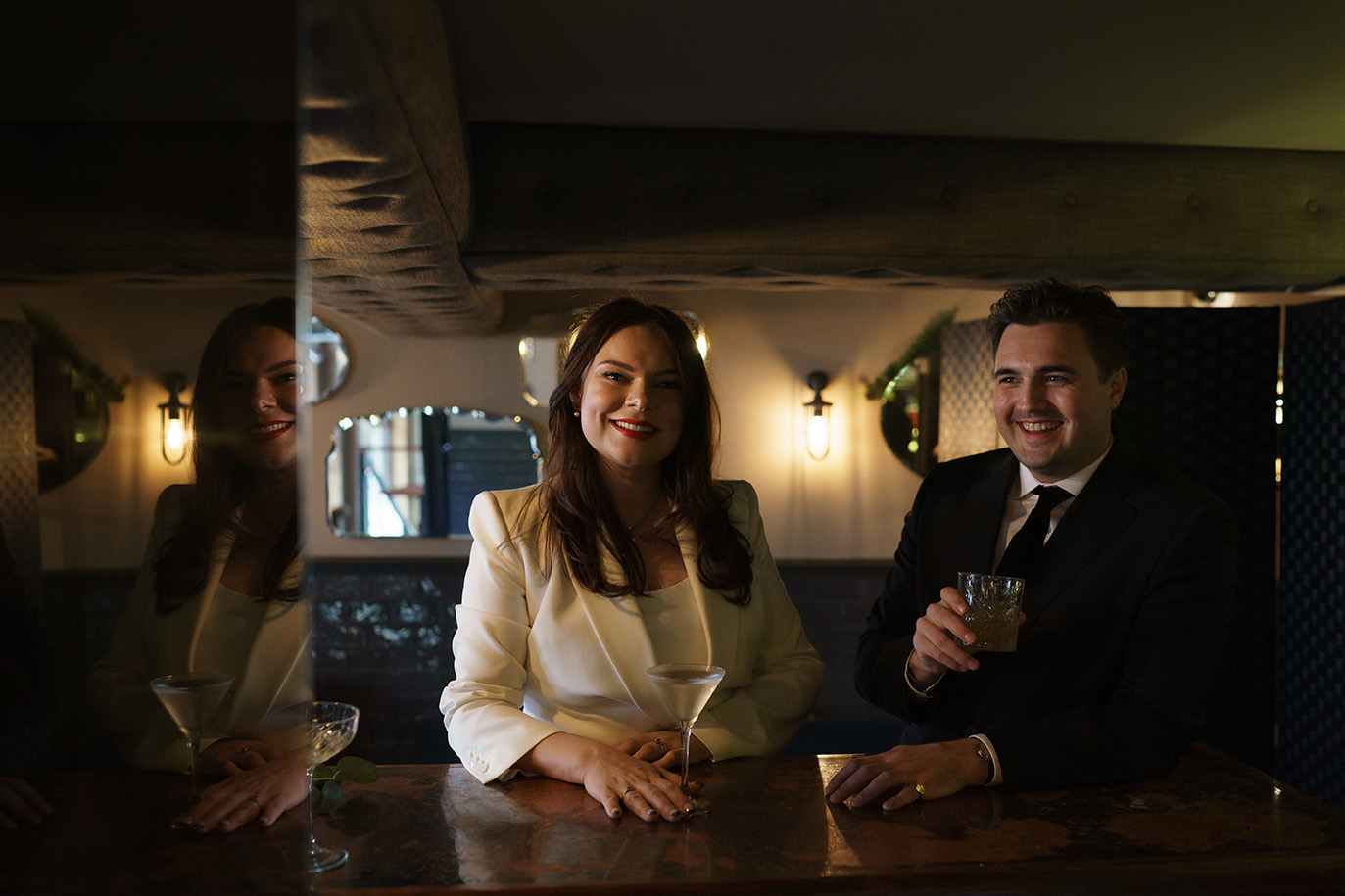 bride and groom drinking cocktails and smiling at balfour at st barts wedding venue