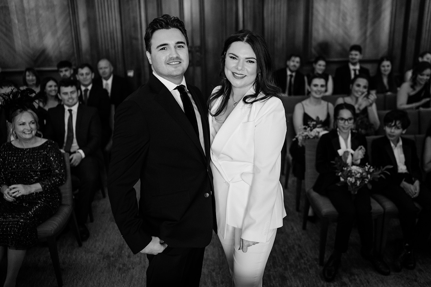 bride and groom looking into the camera for a candid photo at their wedding ceremony at the old marylebone town hall 