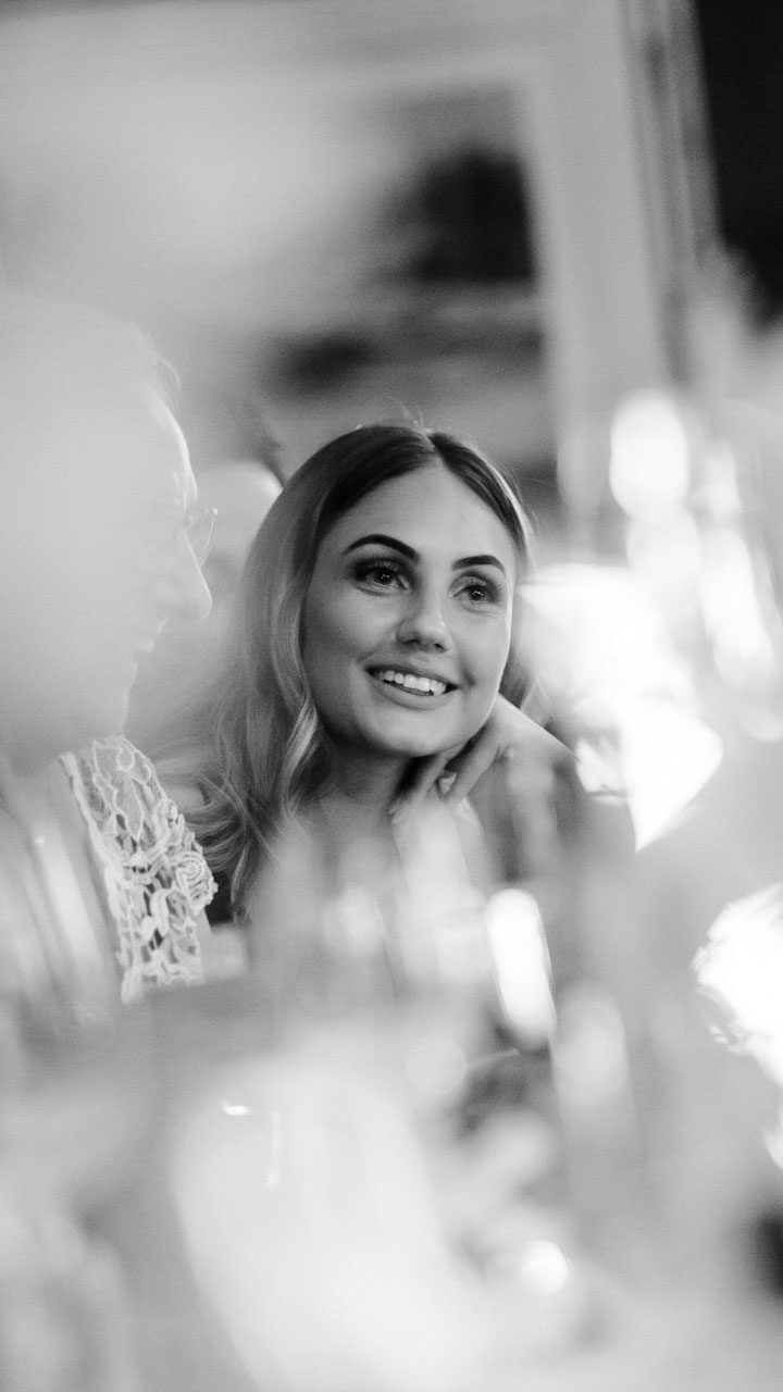 a guest smiling during wedding speeches