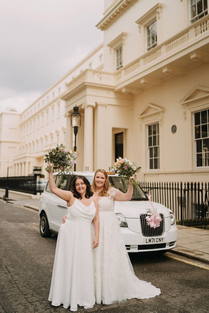 two brides married in front of a wedding taxi and 10-11  Carlton house terrace weddng venue