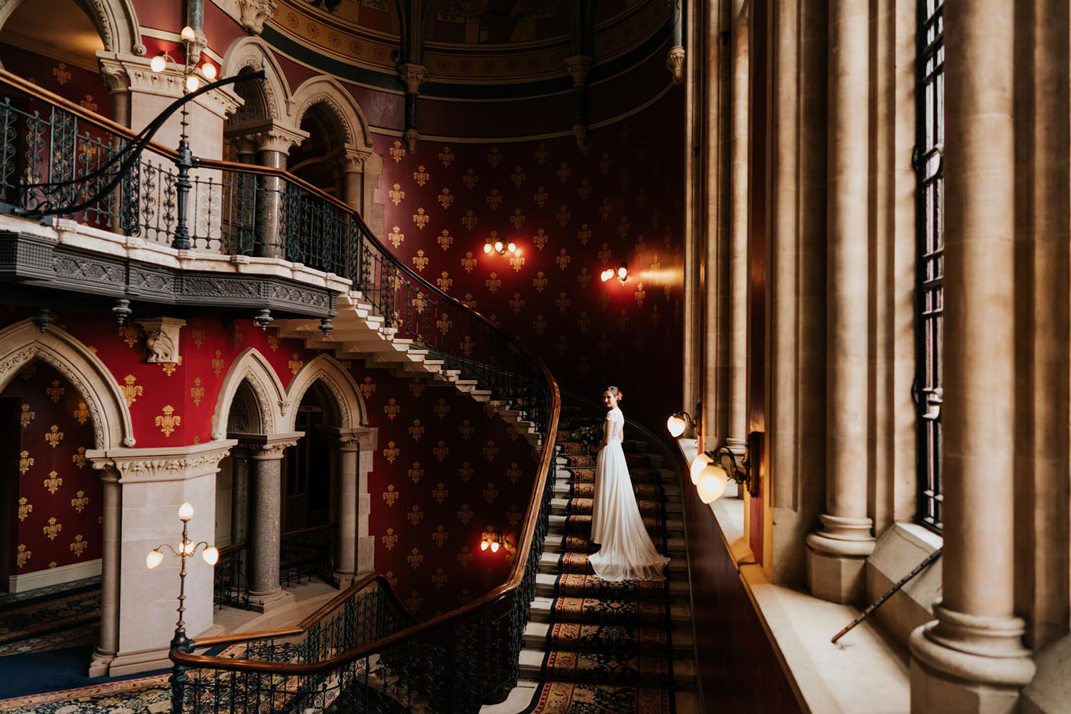 artistic portrait of a bride on the grand staircase at the st pancras renaissance hotel