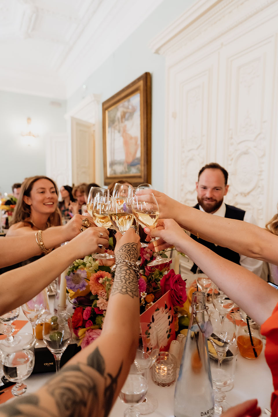 guests clinking glasses and doing a toast at wedding speeches