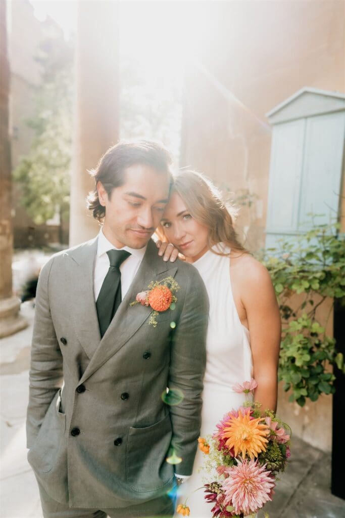 bride leaning on groom basked in sunshine after their old marylebone town hall elopement photographer