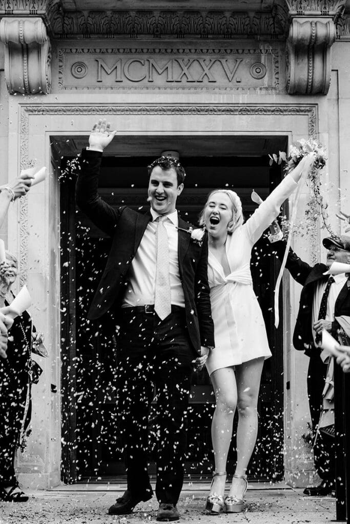 confetti in black and white with bride in short wedding dress at islington town hall