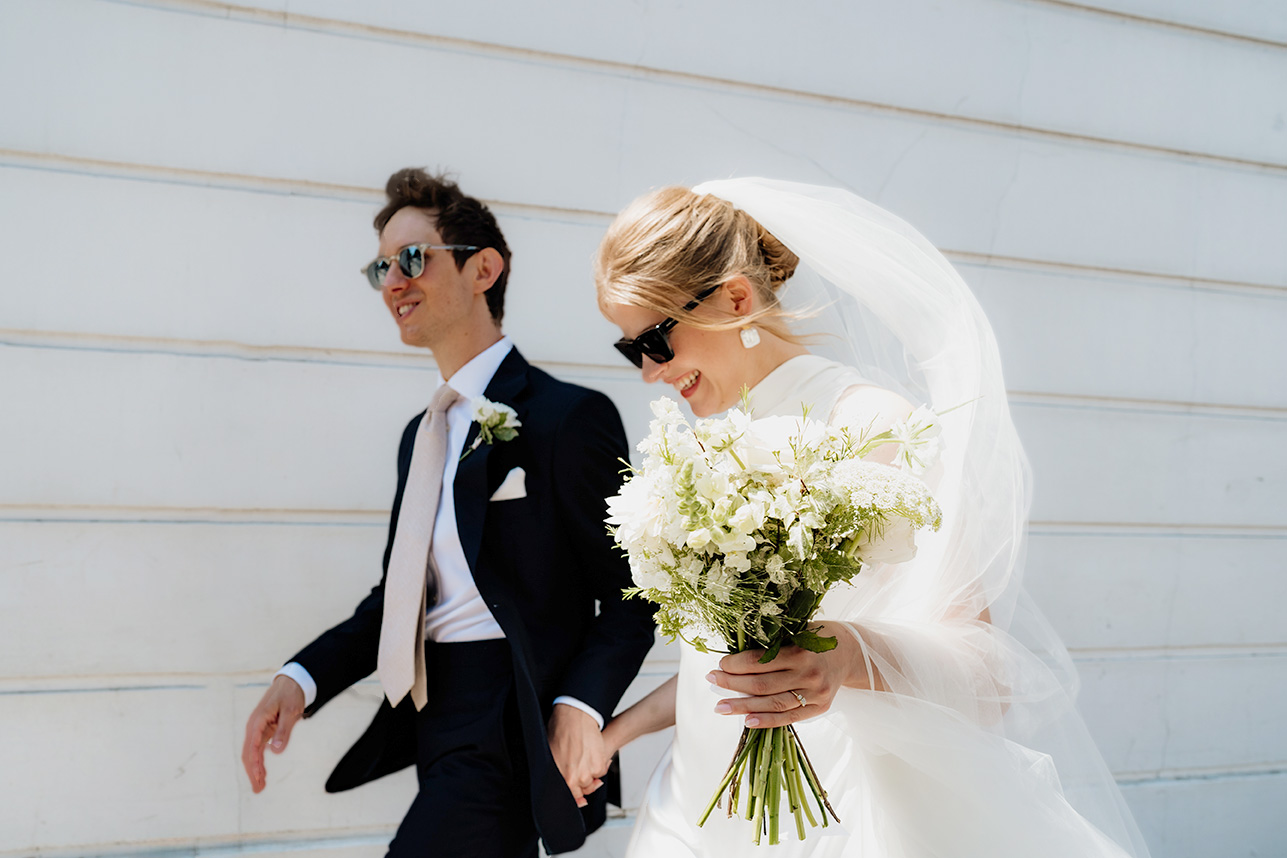 bride and groom walking to the old Marylebone town hall wedding