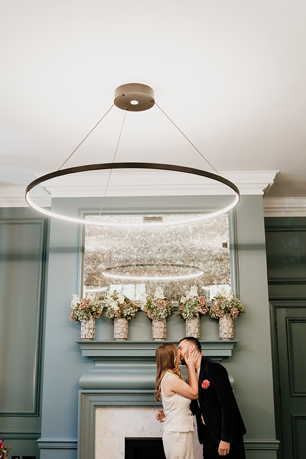 bride and groom first kiss at the knightsbridge room in the old marylebone town hall