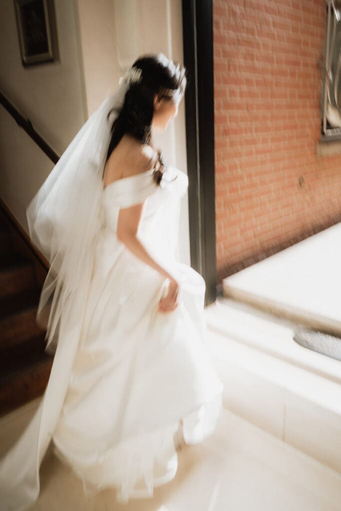 artistic blurry image of a bride walking at the Connaught hotel wedding venue