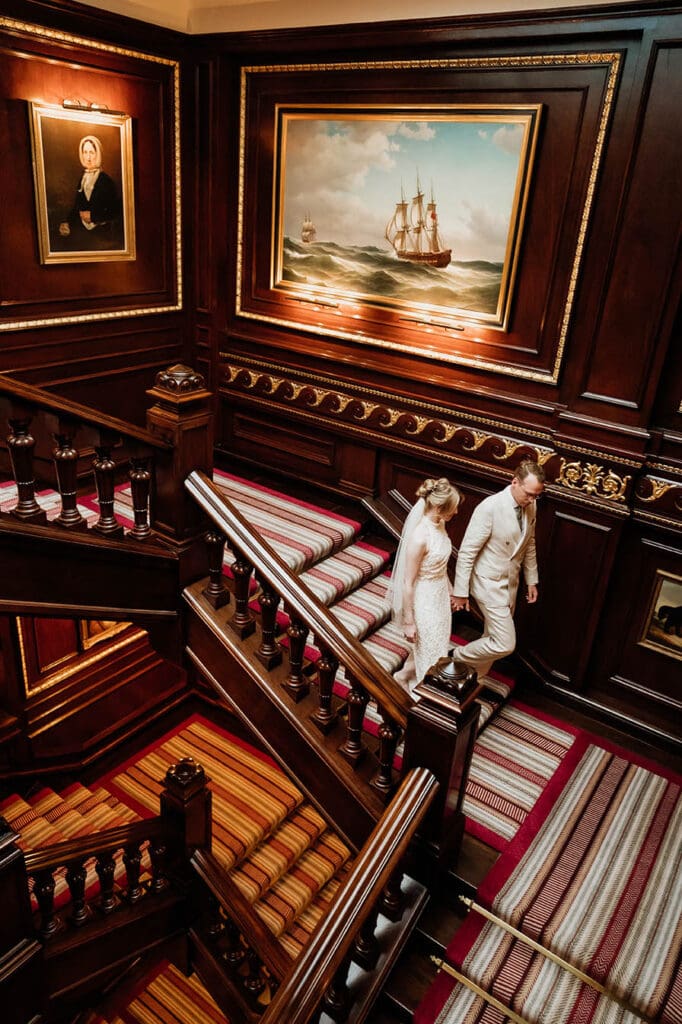 bride and groom walking down the historic staircase of the connaught hotel