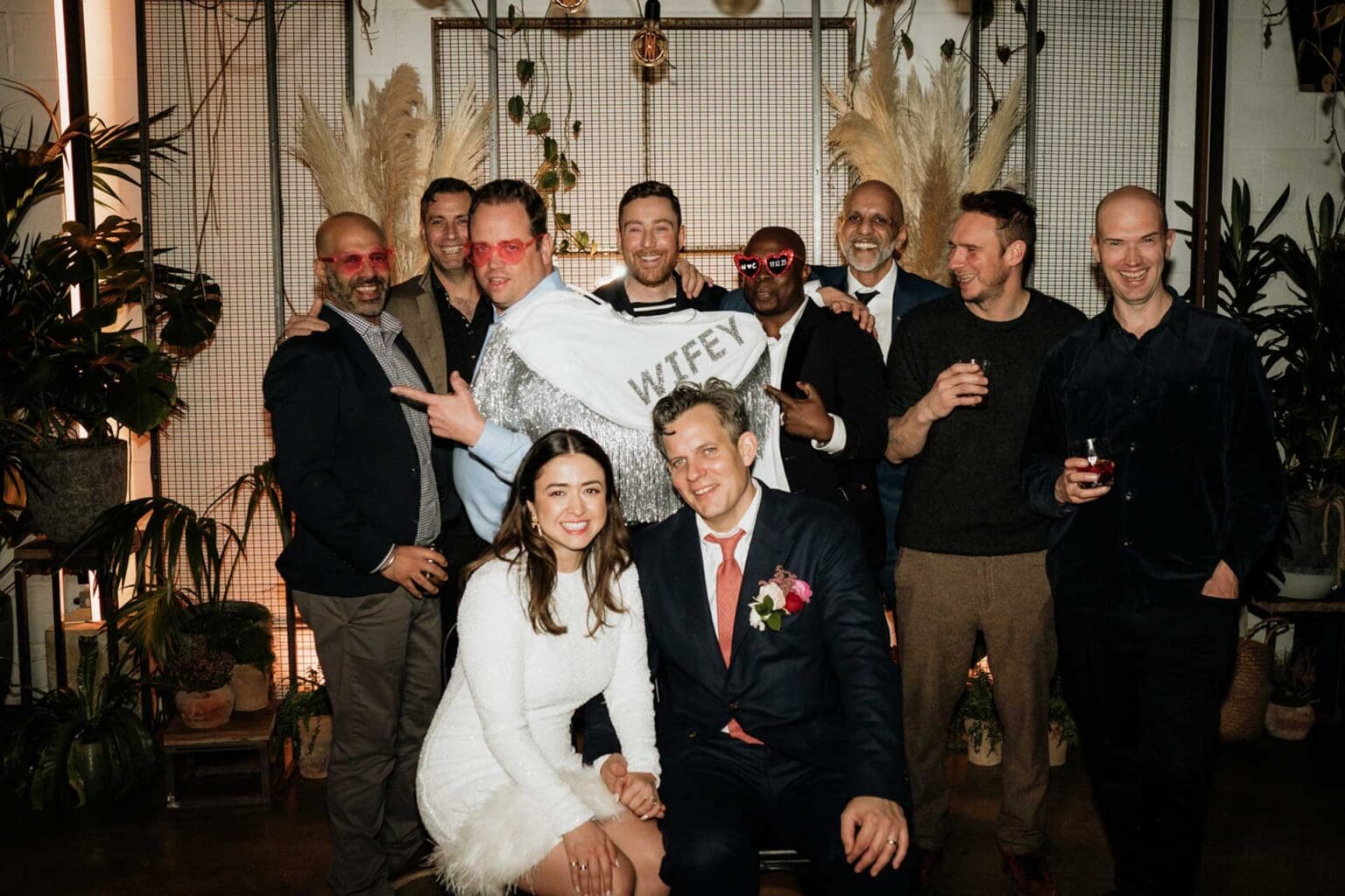 fun group photo with friends taken wedding photographer inside london hackney venue, with flash