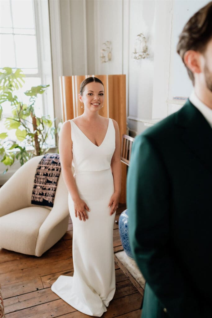 first look with bride waiting to see her groom editorial portrait