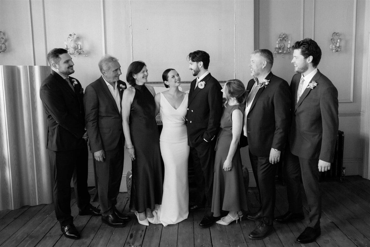 fun, emotive family group portrait indoors in black and white by wedding photographer in london