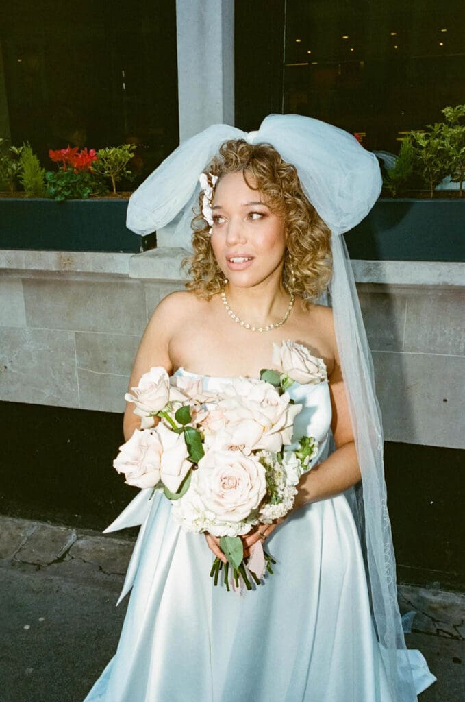 film photography editorial portrait of a bride with flash on a rainy day with moody analogue vibes
