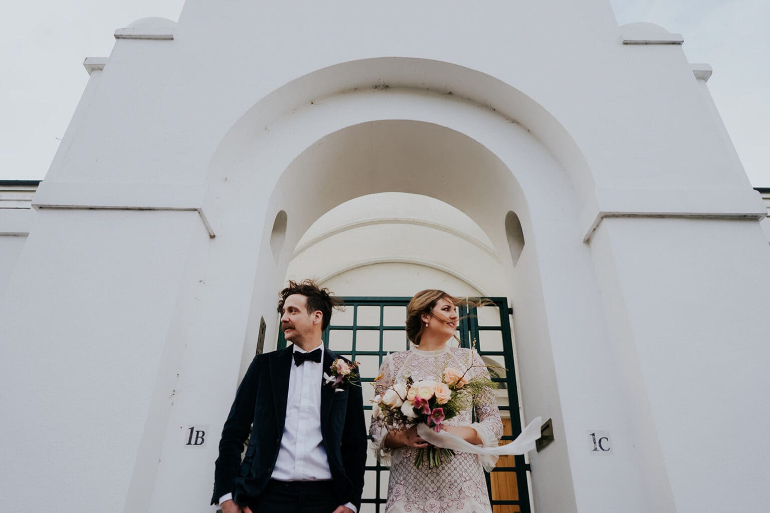 creative wedding photo on a rainy wedding day in islington with bride and groom looking away