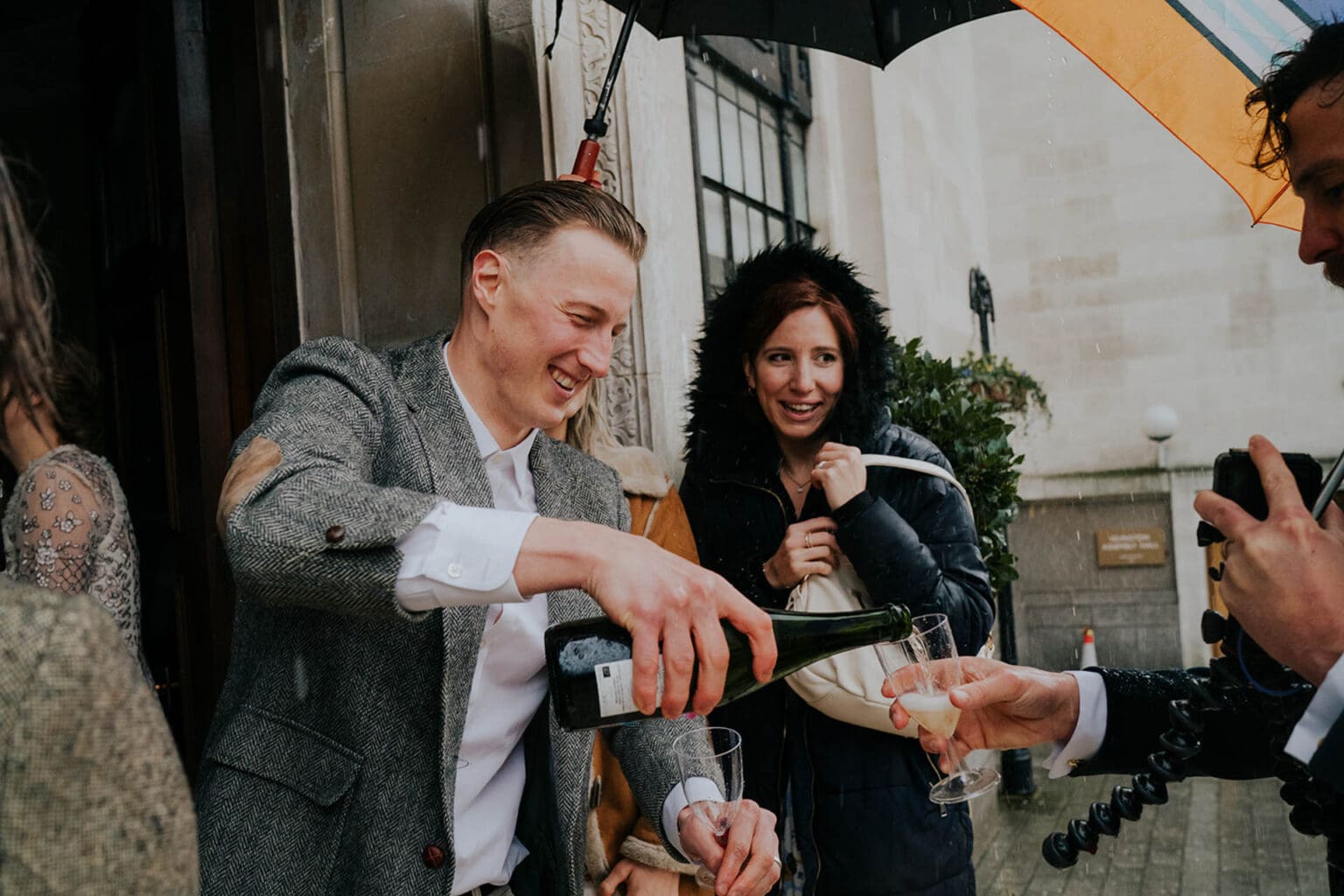 champagne drinks on rainy wedding day in london