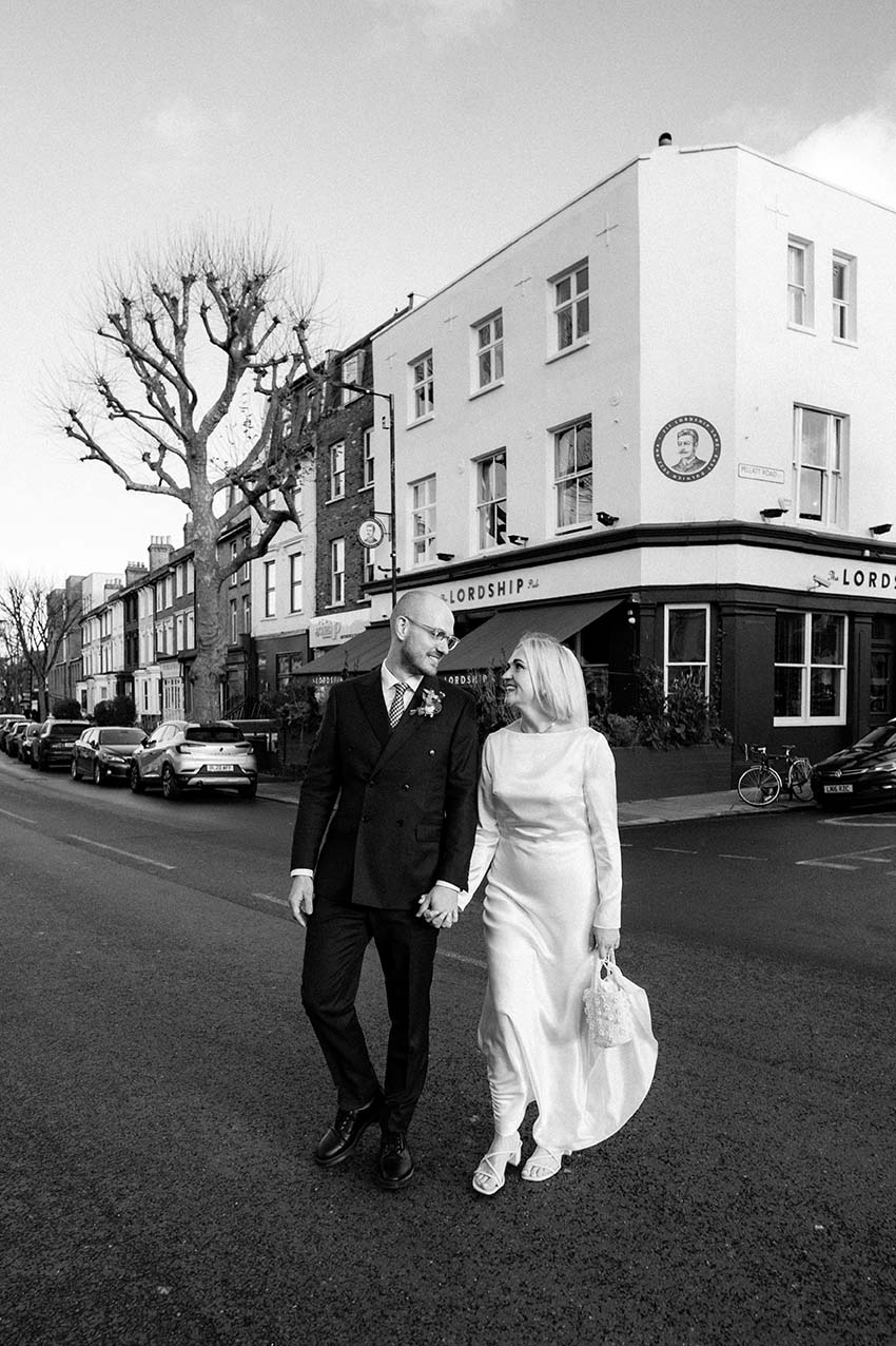 bride and groom looking at each other and walking away from the lordship pub wedding venue in South London